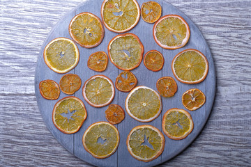 Dried orange slices on gray wooden background