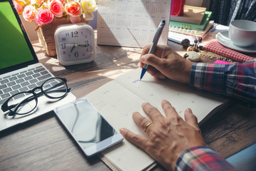 Calendar reminder event concept.Man hand planner or organizer writing on diary book and 2019...