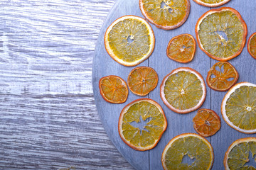 Dried orange slices on gray wooden background