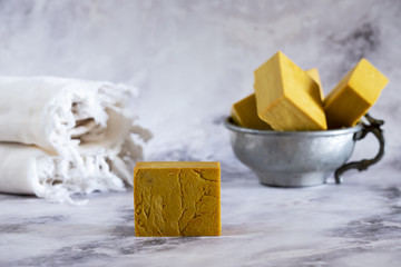 Natural handmade yellow soaps on marble surface