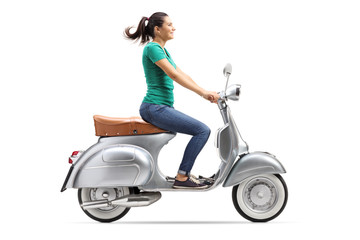 Fototapeta na wymiar Girl riding a vintage scooter
