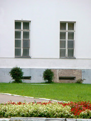 A flowerbed in front of classic white building