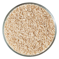 Brown rice in glass bowl isolated on white background
