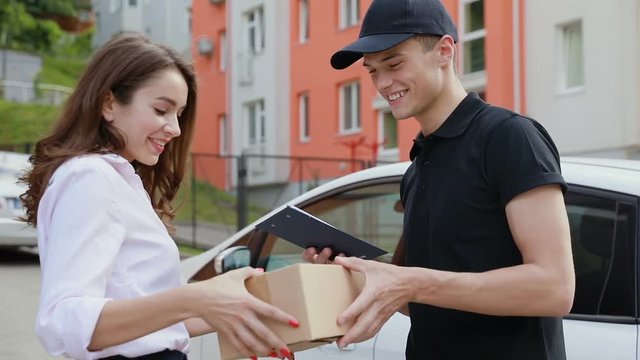 Delivery Service. Courier Delivering Box To Woman