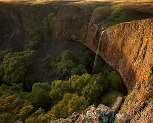 Large waterfall over giant cliff at sunset: Phantom Falls, California