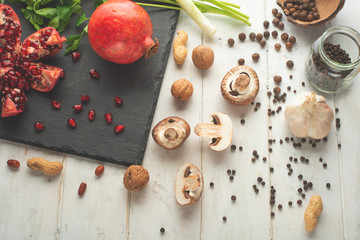 Winter vegetarian, vegan food cooking ingredients. Flat lay of vegetables, fruits, beans, kitchen utensils, olive oil on a white wooden background, top view. Clean and healthy food, detox