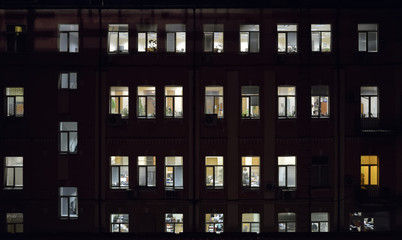 Fototapeta na wymiar Lighted windows of an office working till late