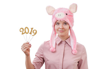 young girl in a pig costume holding in her hands the numbers of 2019, in anticipation of the New Year