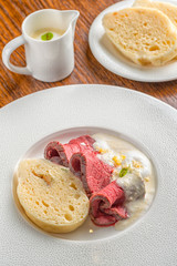 delicious beef with horseradish sauce and dumplings served on white plate, product photography for gastronomy