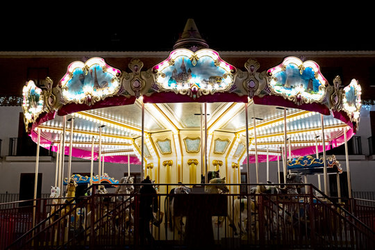 carousel in the center of the Christmas celebrations lit with nice lights and children playing