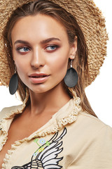 Close up portrait of a beautiful lady with natural makeup, wearing a straw hat, a blouse and long...