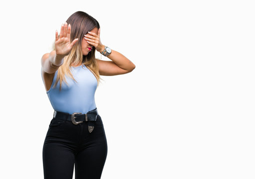Young beautiful elegant business woman over isolated background covering eyes with hands and doing stop gesture with sad and fear expression. Embarrassed and negative concept.