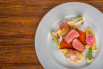delicious pork fillet with potatoes mash and vegetables served on white plate with sauce, product photography  for restaurant