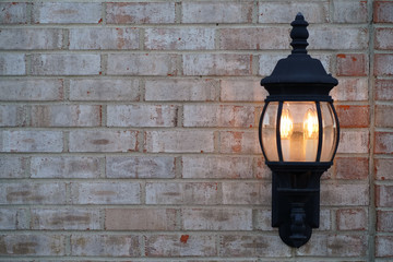 Carriage lights against a white brick wall