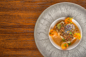 delicious baked fish with vegetable rolls and sauce, served with herbs, product photography for exclusive restaurant