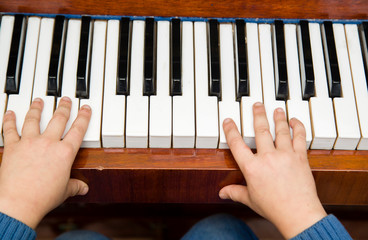 a boy of seven years playing the piano