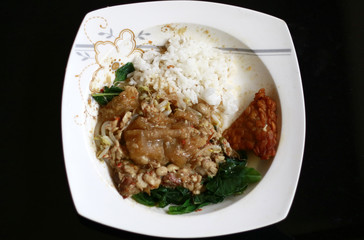 Rice, sprouting, spinach and sambal tumpang. Indonesian traditional food.