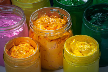 yellow and orange colors of screen printing ink for print on tee shirts and fabric. .plastisol ink useful in tee shirt factory and textile for export...