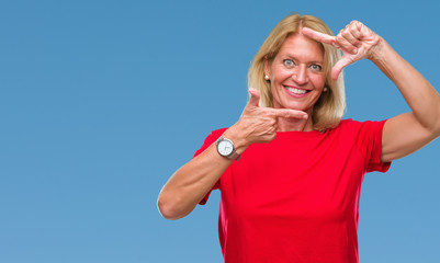 Middle age blonde woman over isolated background smiling making frame with hands and fingers with happy face. Creativity and photography concept.