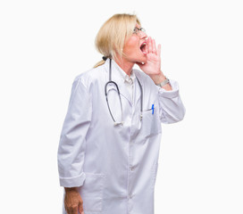 Middle age blonde doctor woman over isolated background shouting and screaming loud to side with hand on mouth. Communication concept.