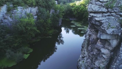 Mountain brook running between ancient rocky walls in the Carpathian in summer