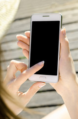 Close Up Business Woman in hat Using Smartphone Mobile Phone Outdoor Black Oled Display Wooden Background Stylish Summer Dressed hipster