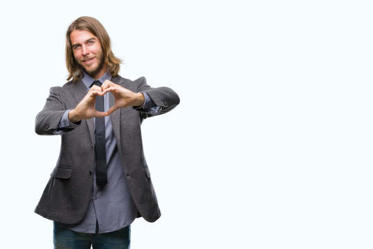 Young handsome business man with long hair over isolated background smiling in love showing heart symbol and shape with hands. Romantic concept.