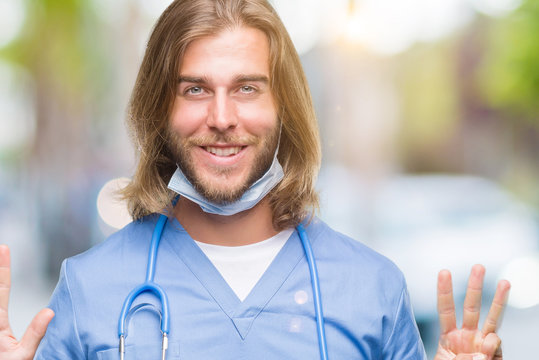 Young handsome doctor man with long hair over isolated background showing and pointing up with fingers number eight while smiling confident and happy.