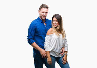 Young couple in love over isolated background winking looking at the camera with sexy expression, cheerful and happy face.