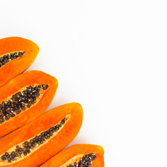Slice of fresh papaya on white background. Flat lay. Top view. Fruit concept