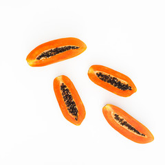 Slice of sweet papaya on white background. Flat lay. Top view. Fruit concept