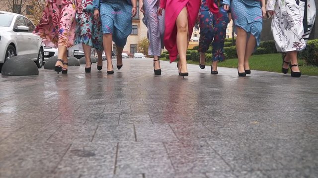 Charming girls in beautiful dresses defile on the street. Plus size Fashion Week. Slow motion.
