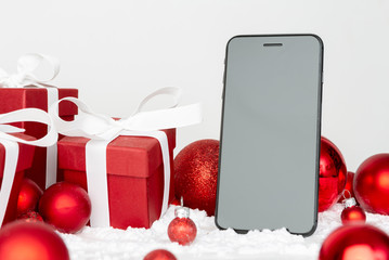 Blank mock up smartphone on a red and white christmas decoration composition