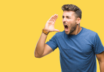 Young handsome man over isolated background shouting and screaming loud to side with hand on mouth. Communication concept.