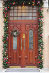 Fototapeta na wymiar Front door with a Christmas wreath. Christmas decorations
