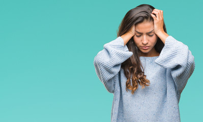 Young beautiful arab woman wearing winter sweater over isolated background suffering from headache...