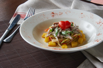 Potato salad with green vegetable on plate