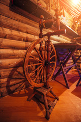 Old traditional Russian wooden spinning wheel in village house