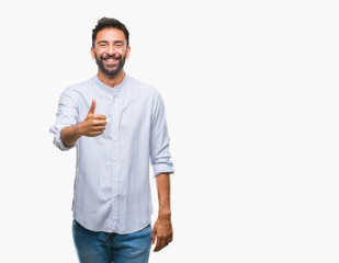 Adult hispanic man over isolated background doing happy thumbs up gesture with hand. Approving...