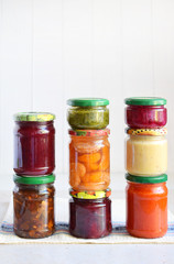 Variety of preserved food in glass jars - pickles, jam, marmalade, sauces, ketchup. Preserving vegetables and fruits. Fermented food. Autumn canning. Conservation of harvest
