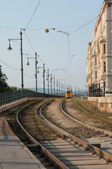 Yellow tram and rails on the embankment of Budapest
