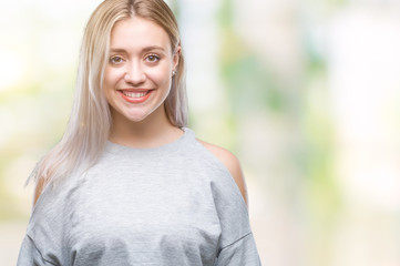 Young blonde woman over isolated background with a happy and cool smile on face. Lucky person.