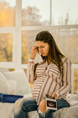 Fototapeta premium Pregnant woman is stressed because of her ultrasound results