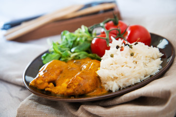 Rice and chicken on white plate