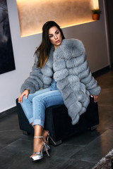 High fashion model in winter fur coat clothes