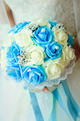 Beautiful bridal bouquet of white and blue roses. Close-up.