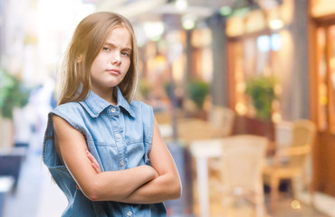 Young beautiful girl over isolated background skeptic and nervous, disapproving expression on face with crossed arms. Negative person.