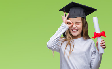 Young beautiful girl wearing graduate cap holding degree over isolated background with happy face...