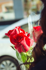 A bouquet of flowers - three red roses.