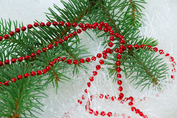 Obraz na płótnie Canvas Christmas branch with red beads